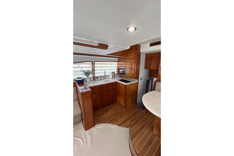 Dream On Yacht Photos Pics Luxurious interior of 2005 Bertram 450 yacht with modern kitchen and wooden finishes.