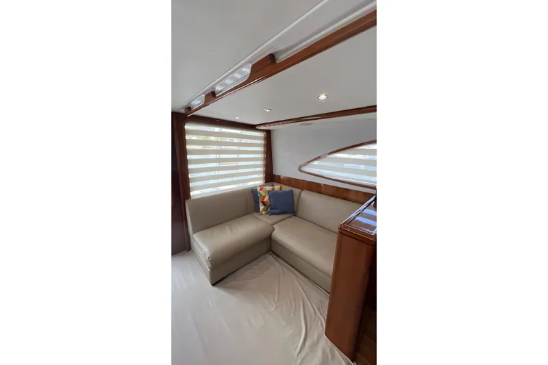 Dream On Yacht Photos Pics Interior of 2005 Bertram 450 yacht with beige seating and decorative pillows.