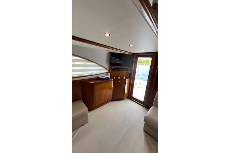 Dream On Yacht Photos Pics Interior of 2005 Bertram 450 yacht with wooden cabinetry and a view of the sea.
