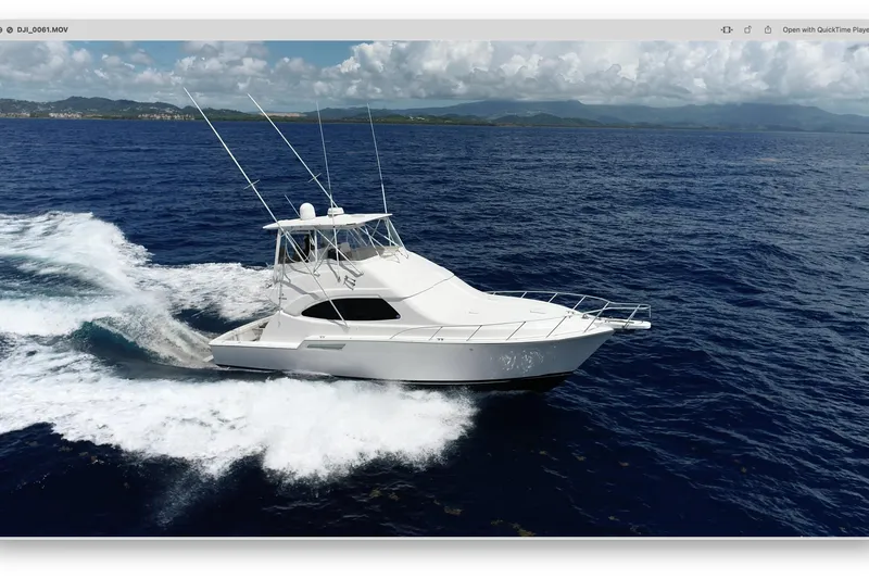 Dream On Yacht Photos Pics A 2005 Bertram 450 yacht cruising on open ocean waters under a cloudy sky.