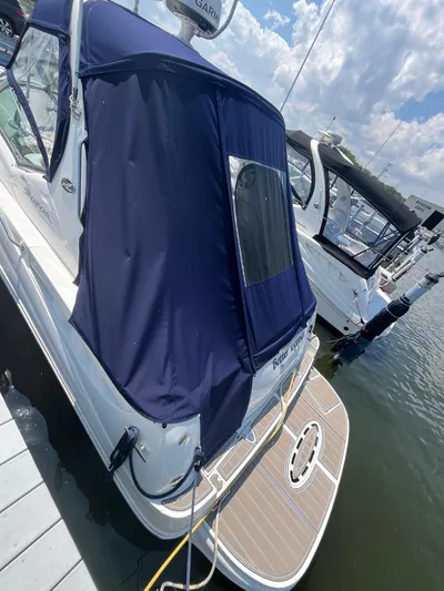  Yacht Photos Pics 2006 Sea Ray 320 Sundancer docked with blue canopy and swim platform.