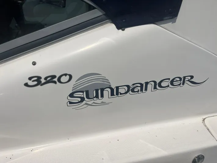  Yacht Photos Pics 2006 Sea Ray 320 Sundancer boat logo on white surface.