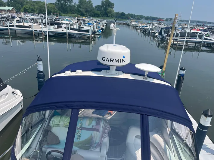  Yacht Photos Pics 2006 Sea Ray 320 Sundancer docked, featuring Garmin equipment, surrounded by marina boats.