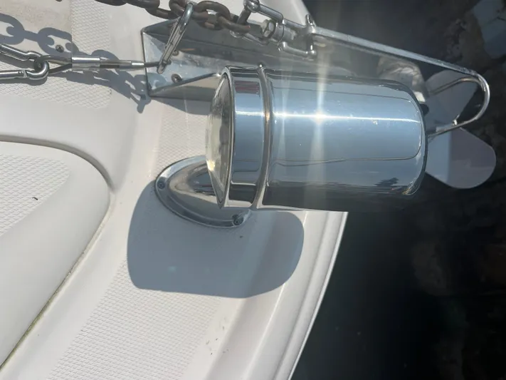  Yacht Photos Pics Close-up of a 2006 Sea Ray 320 Sundancer's anchor chain and spotlight on deck.