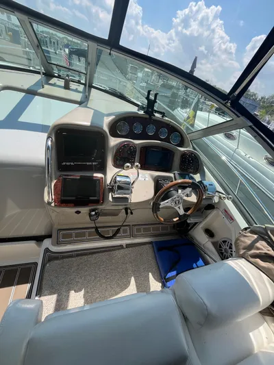  Yacht Photos Pics Helm of 2006 Sea Ray 320 Sundancer with steering wheel and navigation instruments.