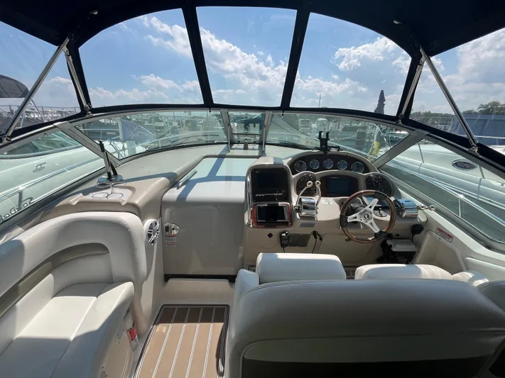  Yacht Photos Pics Interior view of 2006 Sea Ray 320 Sundancer cockpit with steering wheel and control panel.