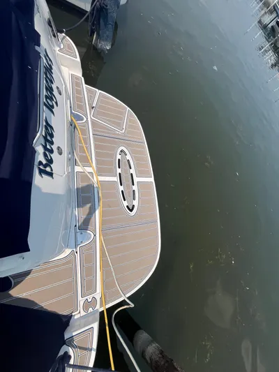  Yacht Photos Pics 2006 Sea Ray 320 Sundancer docked, featuring a spacious swim platform.