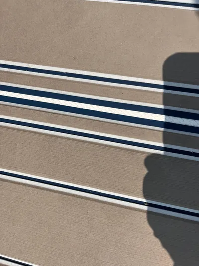  Yacht Photos Pics Striped deck surface of a 2006 Sea Ray 320 Sundancer boat.