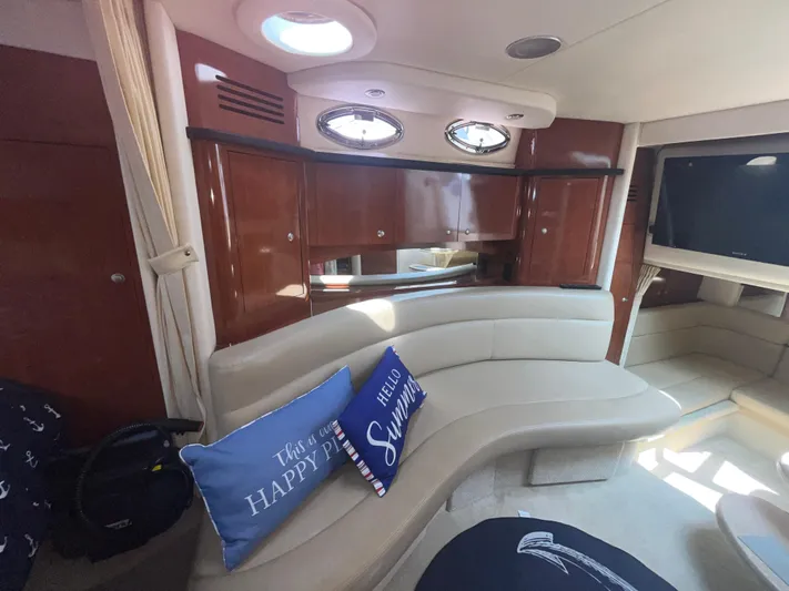  Yacht Photos Pics Interior of 2006 Sea Ray 320 Sundancer with curved seating and decorative pillows.