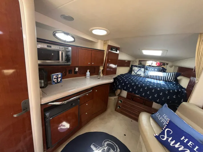  Yacht Photos Pics 2006 Sea Ray 320 Sundancer cabin interior with kitchenette and cozy sleeping area.