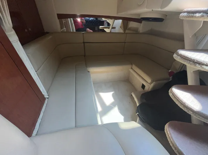  Yacht Photos Pics Interior of 2006 Sea Ray 320 Sundancer with beige seating and wooden accents.