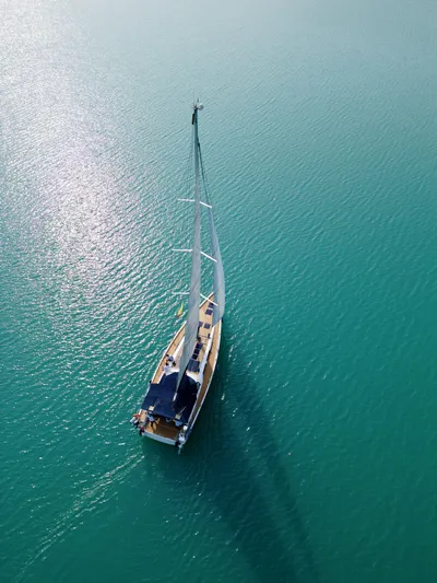  Yacht Photos Pics Aerial view of 2014 Hanse 575 sailboat on turquoise water.