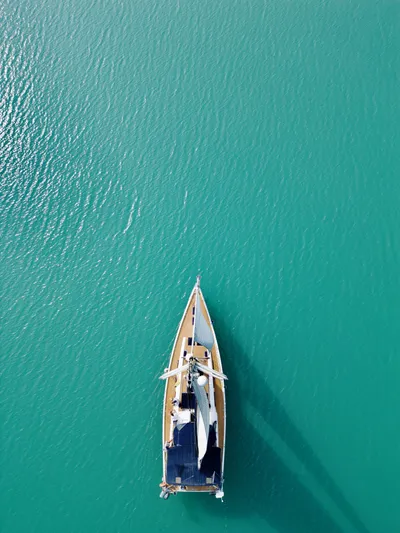  Yacht Photos Pics Aerial view of a 2014 Hanse 575 sailboat on turquoise water.