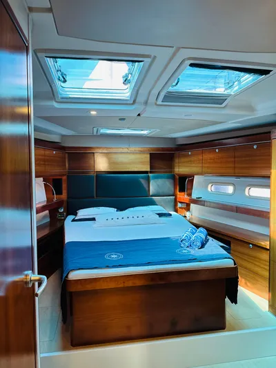  Yacht Photos Pics Luxurious cabin interior of 2014 Hanse 575 yacht with skylights and wooden finishes.