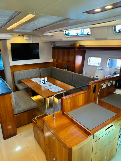  Yacht Photos Pics Interior of 2014 Hanse 575 yacht with modern kitchen and cozy dining area.