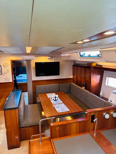 Yacht Photos Pics Interior of 2014 Hanse 575 yacht with cozy dining area and modern amenities.
