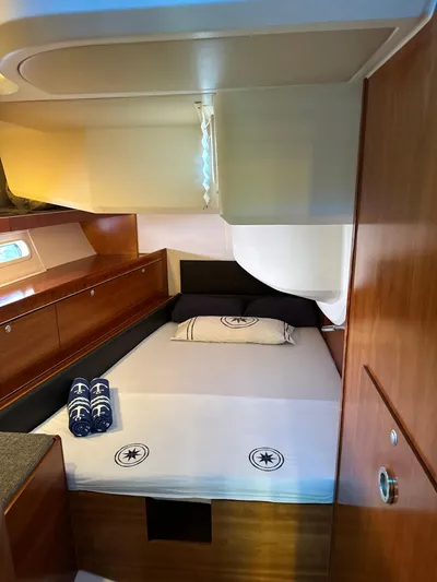  Yacht Photos Pics Luxurious cabin interior of a 2014 Hanse 575 yacht with a neatly made bed.