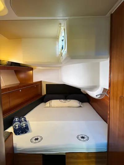  Yacht Photos Pics Luxurious cabin interior of a 2014 Hanse 575 yacht with neatly arranged bedding.