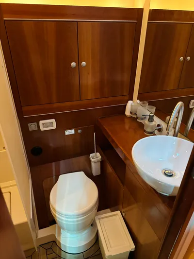  Yacht Photos Pics 2014 Hanse 575 yacht bathroom with wooden cabinets and modern fixtures.