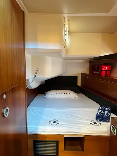  Yacht Photos Pics Cozy cabin interior of 2014 Hanse 575 sailboat with bed and storage.