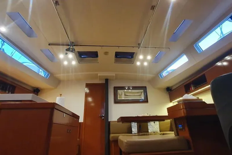 Mareo Yacht Photos Pics Interior of 2018 Beneteau Oceanis 55.1 yacht, featuring elegant wood finishes and ample natural light.