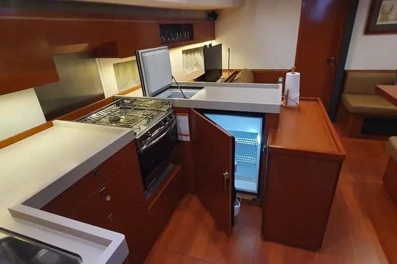 Mareo Yacht Photos Pics Interior of 2018 Beneteau Oceanis 55.1 yacht kitchen with modern appliances and wood finish.