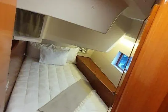 Mareo Yacht Photos Pics Cozy cabin interior of 2018 Beneteau Oceanis 55.1 yacht with bed and window.