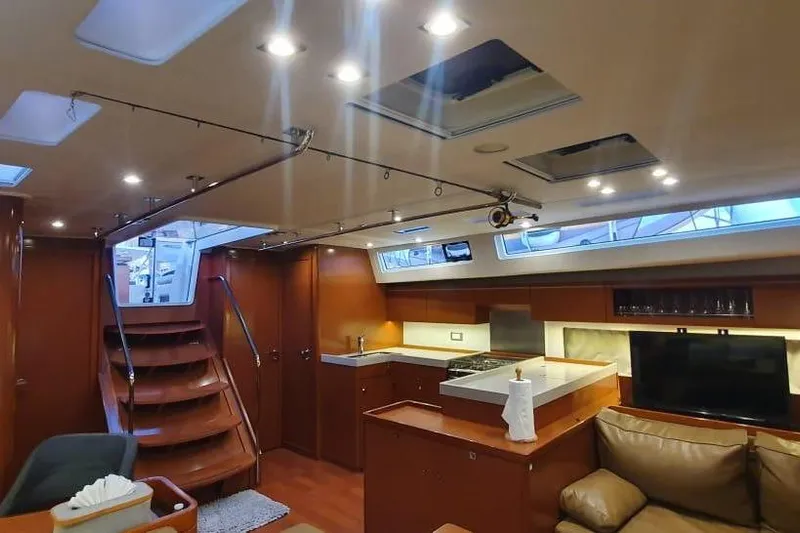 Mareo Yacht Photos Pics Luxurious interior of 2018 Beneteau Oceanis 55.1 yacht with modern kitchen and seating area.