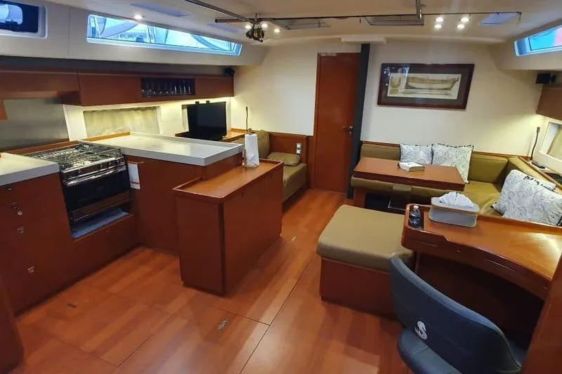 Mareo Yacht Photos Pics Luxurious interior of 2018 Beneteau Oceanis 55.1 yacht with modern kitchen and seating area.