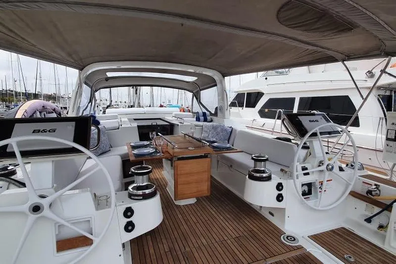 Mareo Yacht Photos Pics 2018 Beneteau Oceanis 55.1 yacht cockpit with dual steering wheels and elegant seating area.