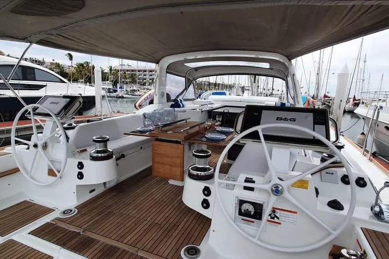 Mareo Yacht Photos Pics 2018 Beneteau Oceanis 55.1 yacht cockpit with dual steering wheels and teak flooring.