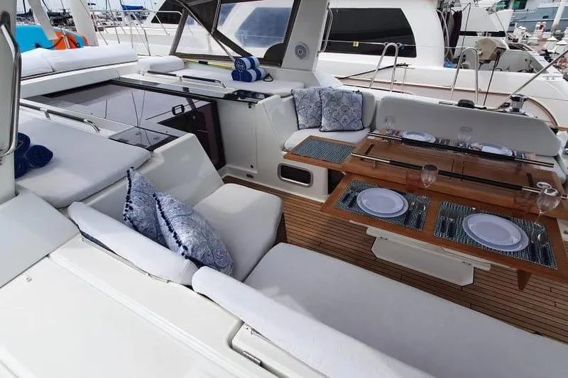 Mareo Yacht Photos Pics Luxurious 2018 Beneteau Oceanis 55.1 yacht interior with elegant dining setup and plush seating.