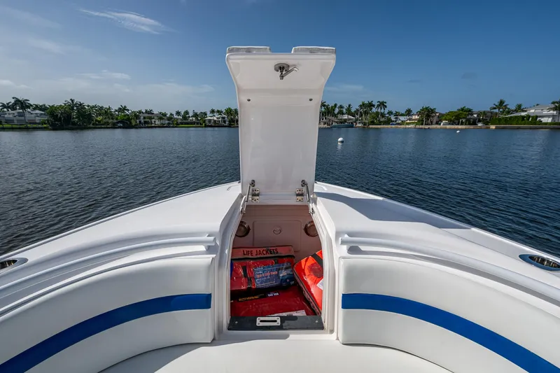 Christyl Clear Yacht Photos Pics 2018 Intrepid 327 Center Console boat with open storage compartment, life jackets visible.