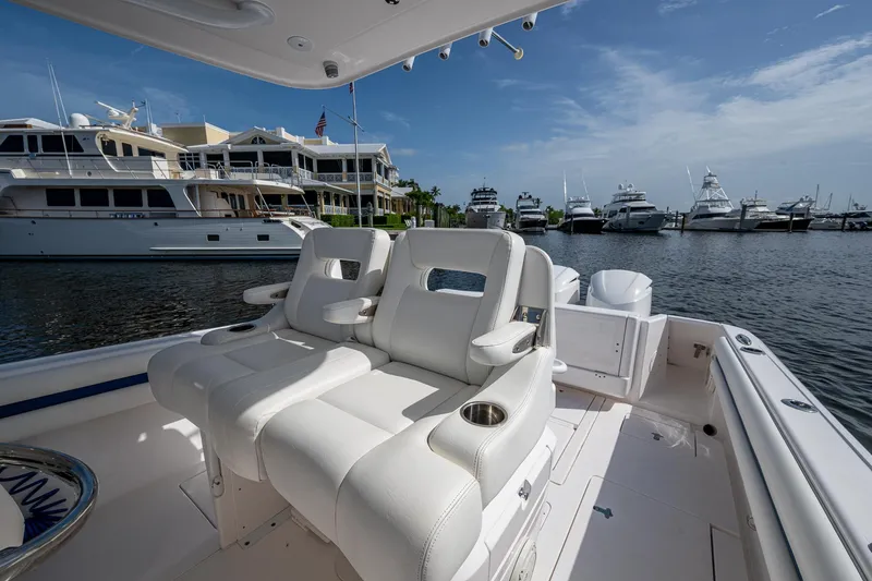 Christyl Clear Yacht Photos Pics 2018 Intrepid 327 Center Console boat with luxurious seating, docked near yachts.