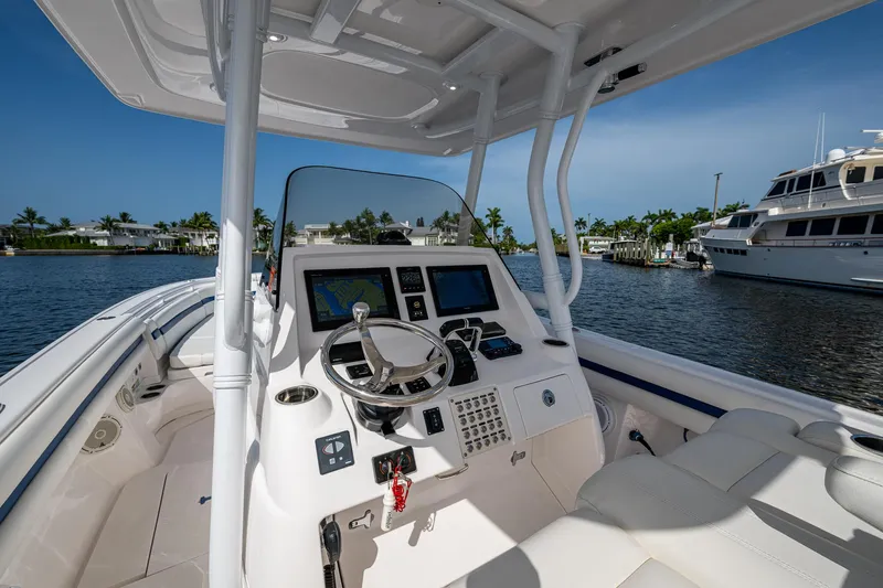 Christyl Clear Yacht Photos Pics 2018 Intrepid 327 Center Console boat interior with steering wheel and navigation screens.