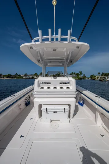 Christyl Clear Yacht Photos Pics 2018 Intrepid 327 Center Console boat on calm water, showcasing helm and seating area.