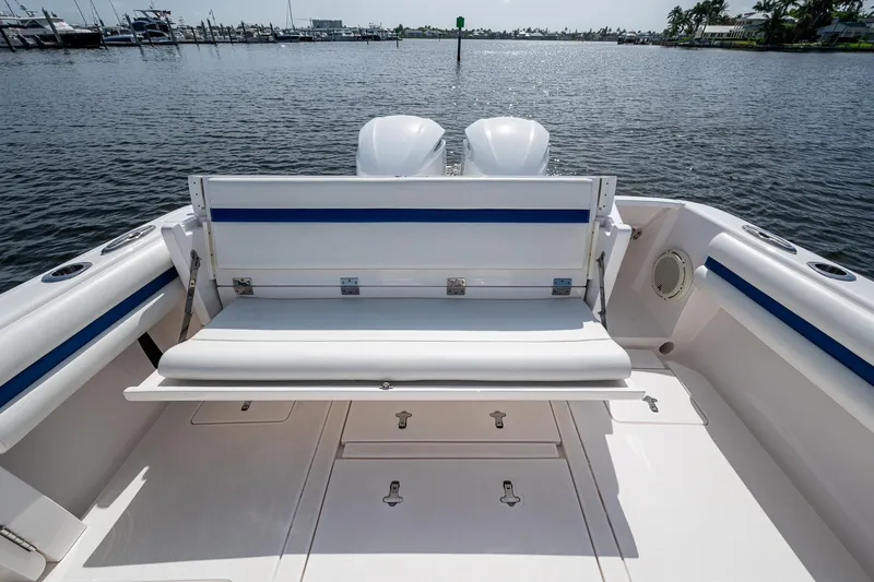 Christyl Clear Yacht Photos Pics 2018 Intrepid 327 Center Console boat with seating, docked on calm water.
