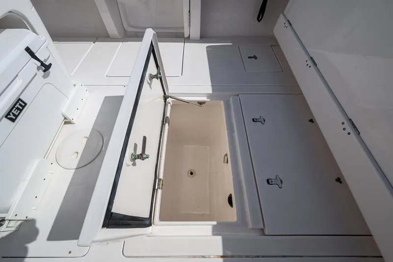 Christyl Clear Yacht Photos Pics 2018 Intrepid 327 Center Console open storage compartment with Yeti cooler on deck.