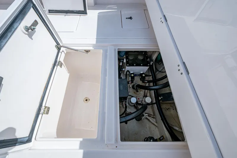 Christyl Clear Yacht Photos Pics Open storage compartments on a 2018 Intrepid 327 Center Console boat, showing internal components.