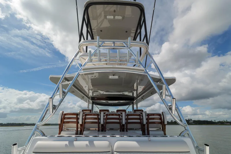 Lucky 24 IV Yacht Photos Pics 2024 Valhalla Boatworks V-55, rear view with seating, under a cloudy sky.