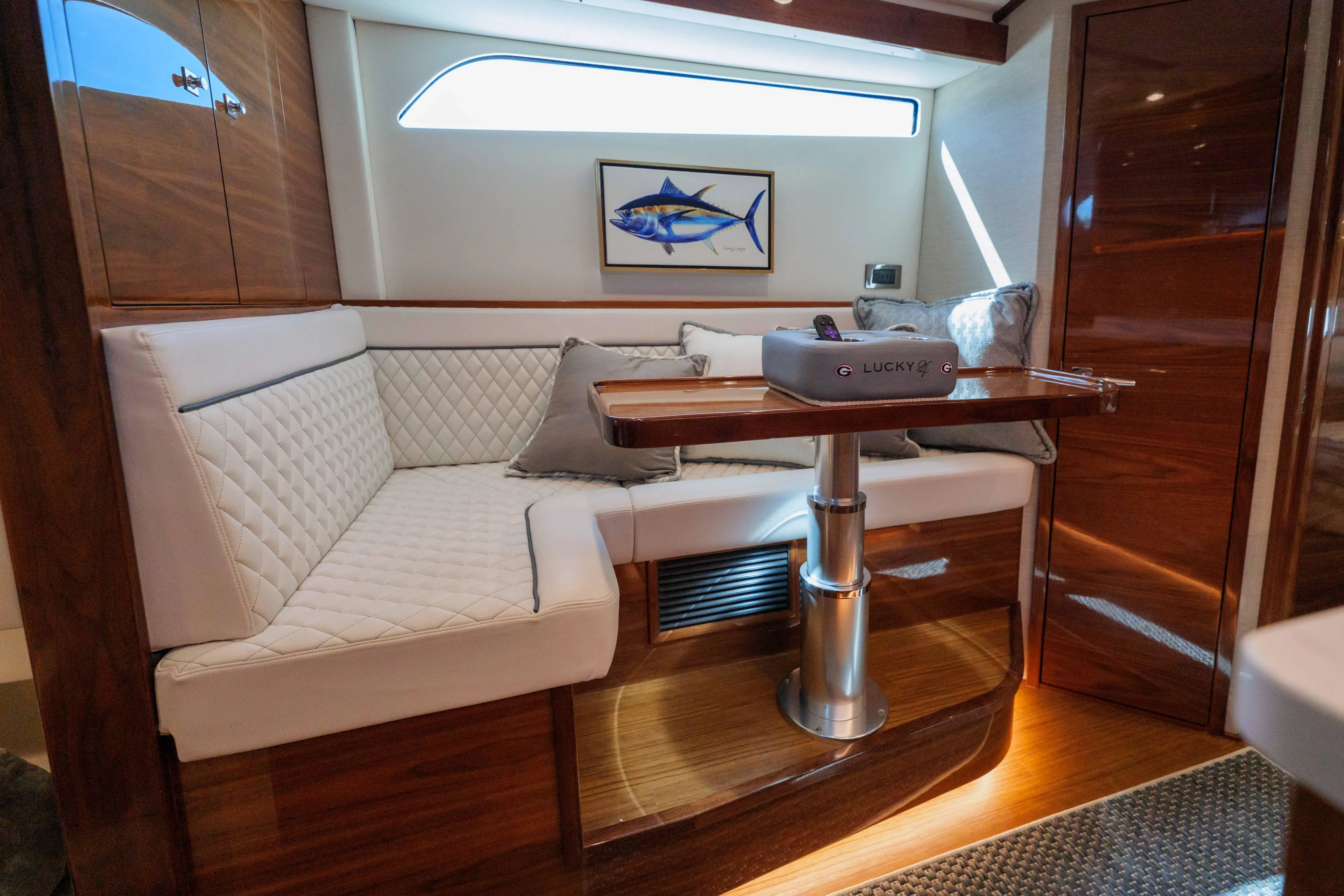 Lucky 24 IV Yacht Photos Pics Luxurious interior of 2024 Valhalla Boatworks V-55 with elegant seating and wooden finishes.