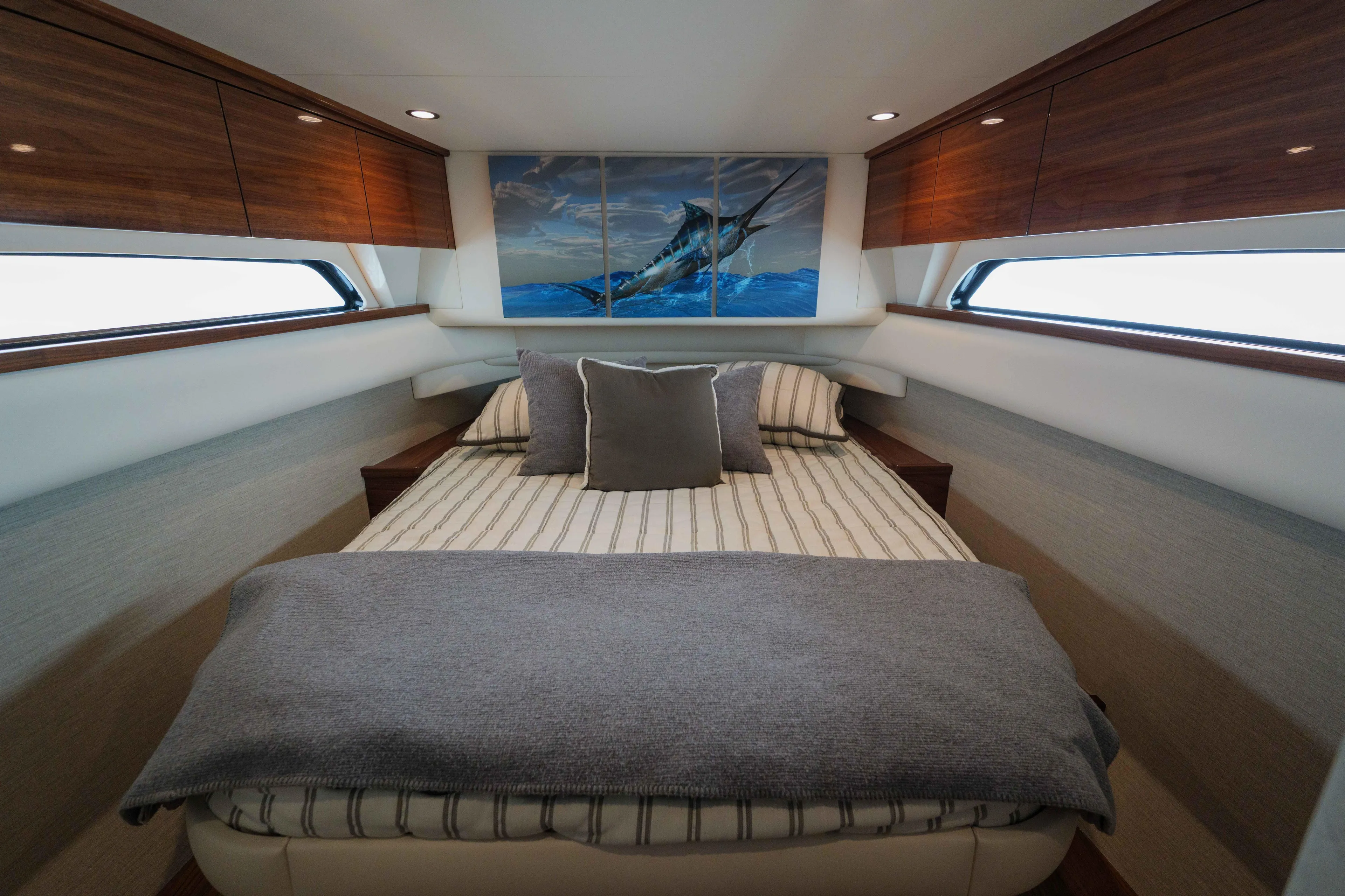 Lucky 24 IV Yacht Photos Pics Luxurious 2024 Valhalla V-55 boat cabin with elegant bedding and wooden cabinetry.