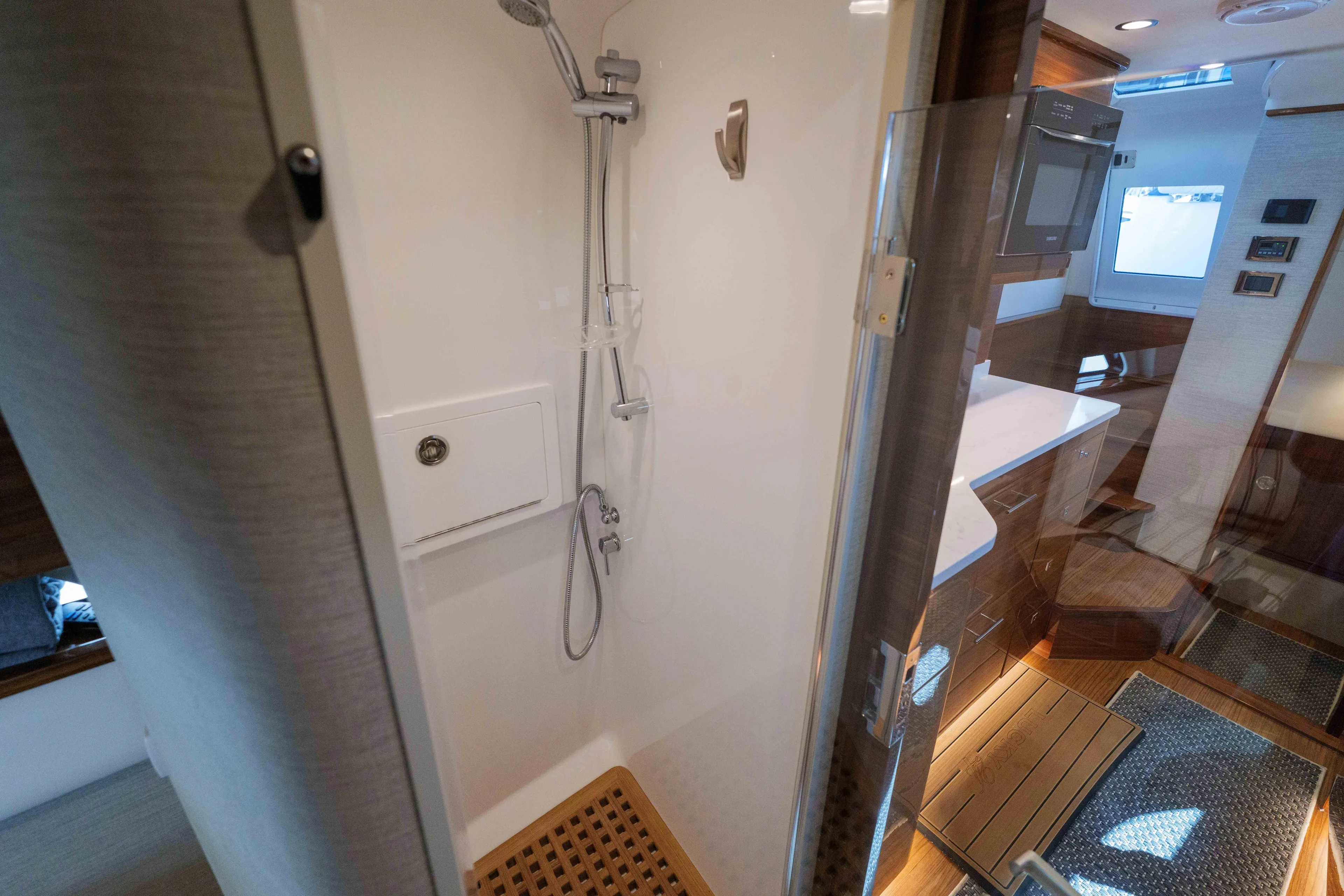 Lucky 24 IV Yacht Photos Pics 2024 Valhalla V-55 boat interior with modern shower and sleek wooden cabinetry.