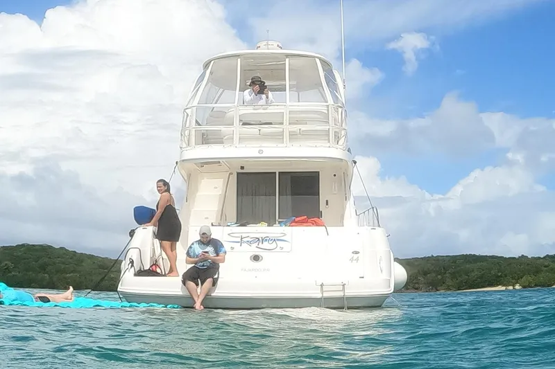 Get N Free Yacht Photos Pics 2006 Sea Ray 44 Sedan Bridge yacht with people enjoying a sunny day on the water.