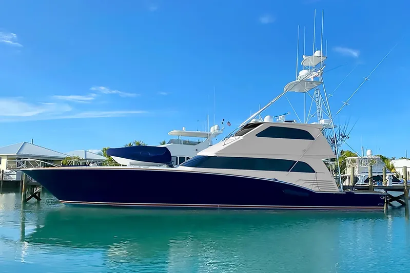 Reel Deal Yacht Photos Pics 2005 Sea Force Sportfish yacht docked in a marina under clear blue skies.