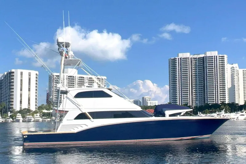 Reel Deal Yacht Photos Pics 2005 Sea Force IX Sportfish yacht on water with city skyline background.
