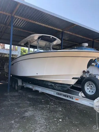 Dos Amigos Yacht Photos Pics 2006 Grady-White Bimini 306 boat on trailer under metal shelter.