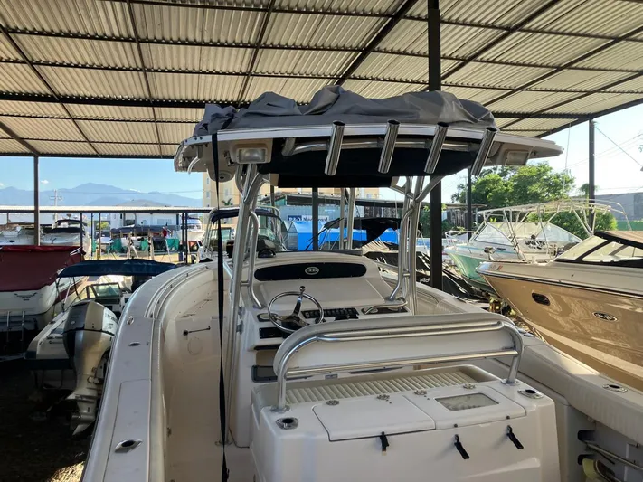Dos Amigos Yacht Photos Pics 2006 Grady-White Bimini 306 boat in covered storage, surrounded by other vessels.