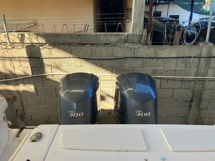 Dos Amigos Yacht Photos Pics 2006 Grady-White Bimini 306 with twin Yamaha 300 engines, docked near concrete wall.