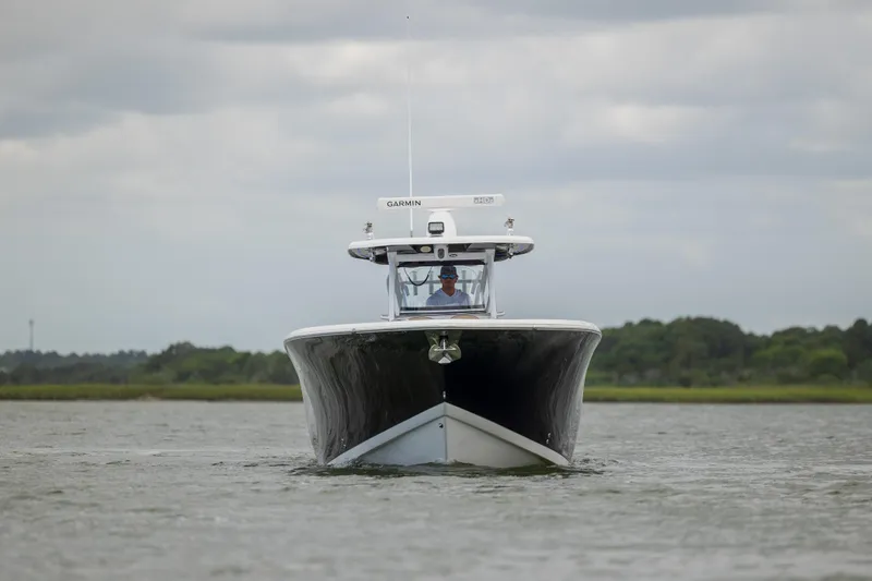  Yacht Photos Pics 2020 Tidewater 320 CC Adventure boat on water, front view, overcast sky.